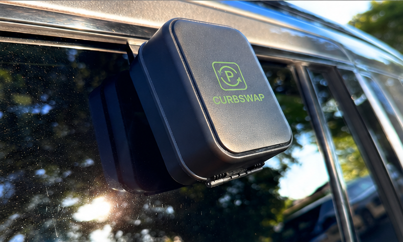 The Curbswap SwapBox mounted on a car window